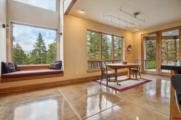 a living room filled with furniture and a large window