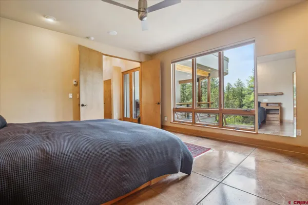 a bedroom with a bed and a large window