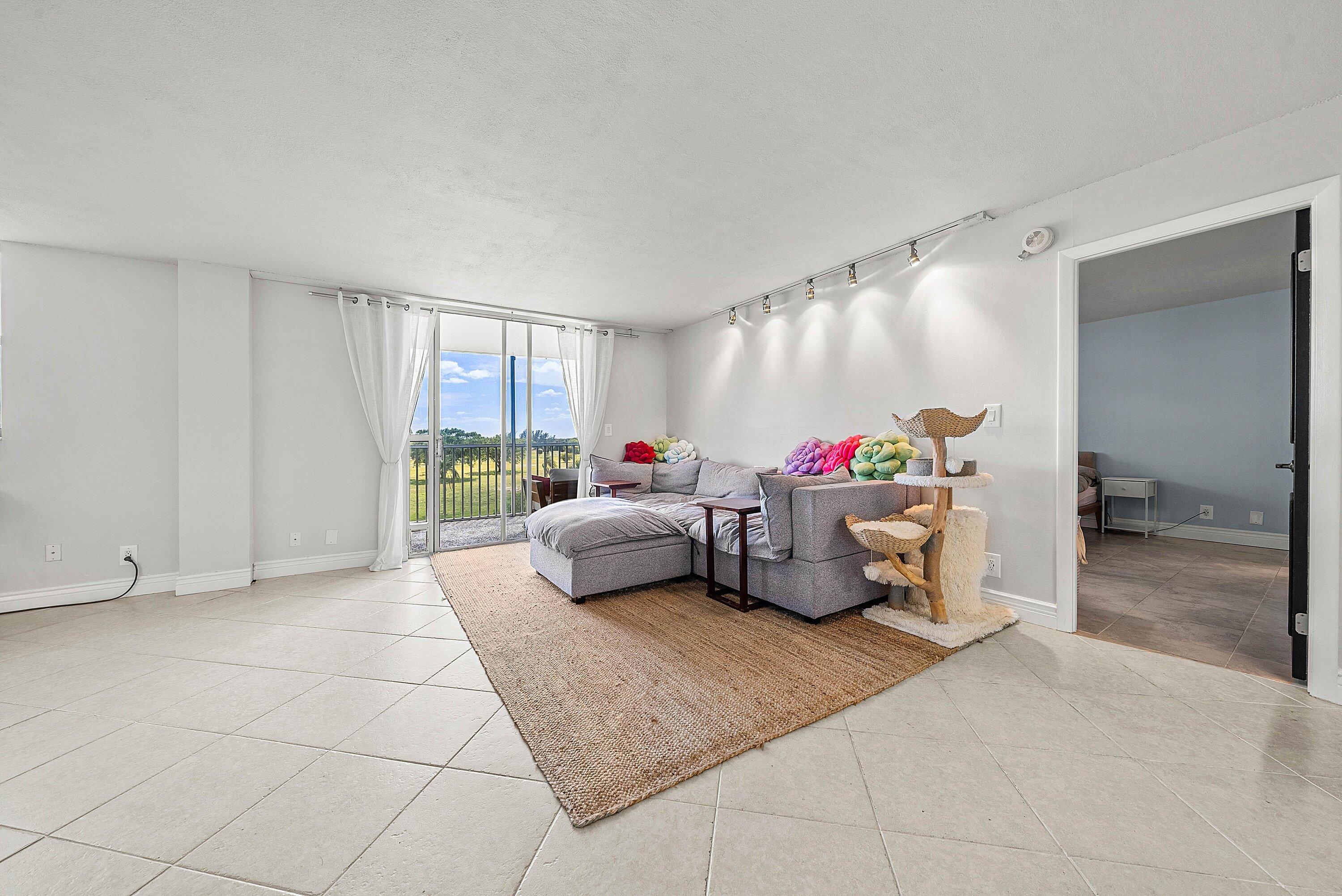 6699 Northwest 2nd Avenue, Unit 415 Boca Raton, FL 33487 - Photo 11 of 27 a bed room with furniture and a window