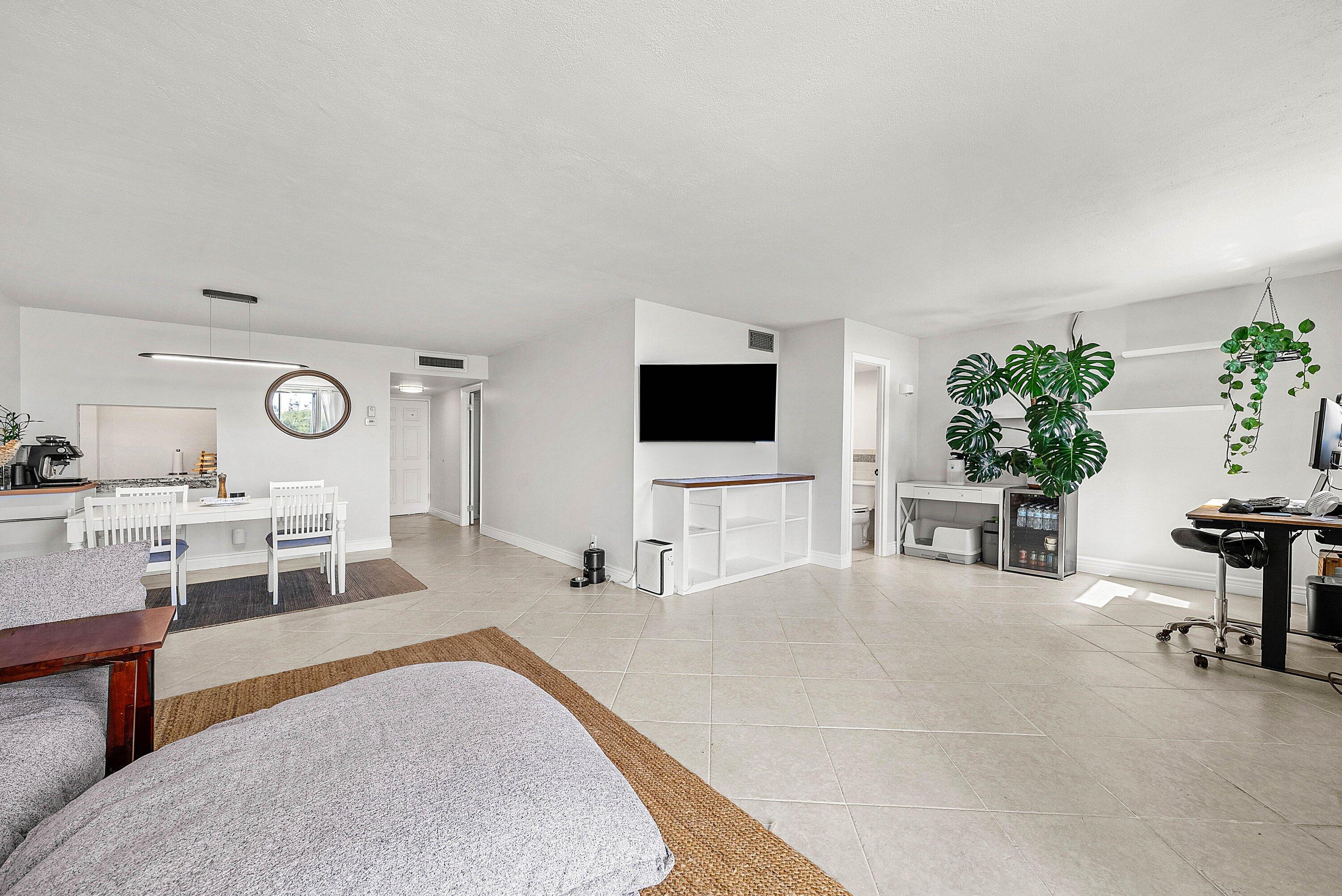 6699 Northwest 2nd Avenue, Unit 415 Boca Raton, FL 33487 - Photo 13 of 27 a living room with furniture and a flat screen tv