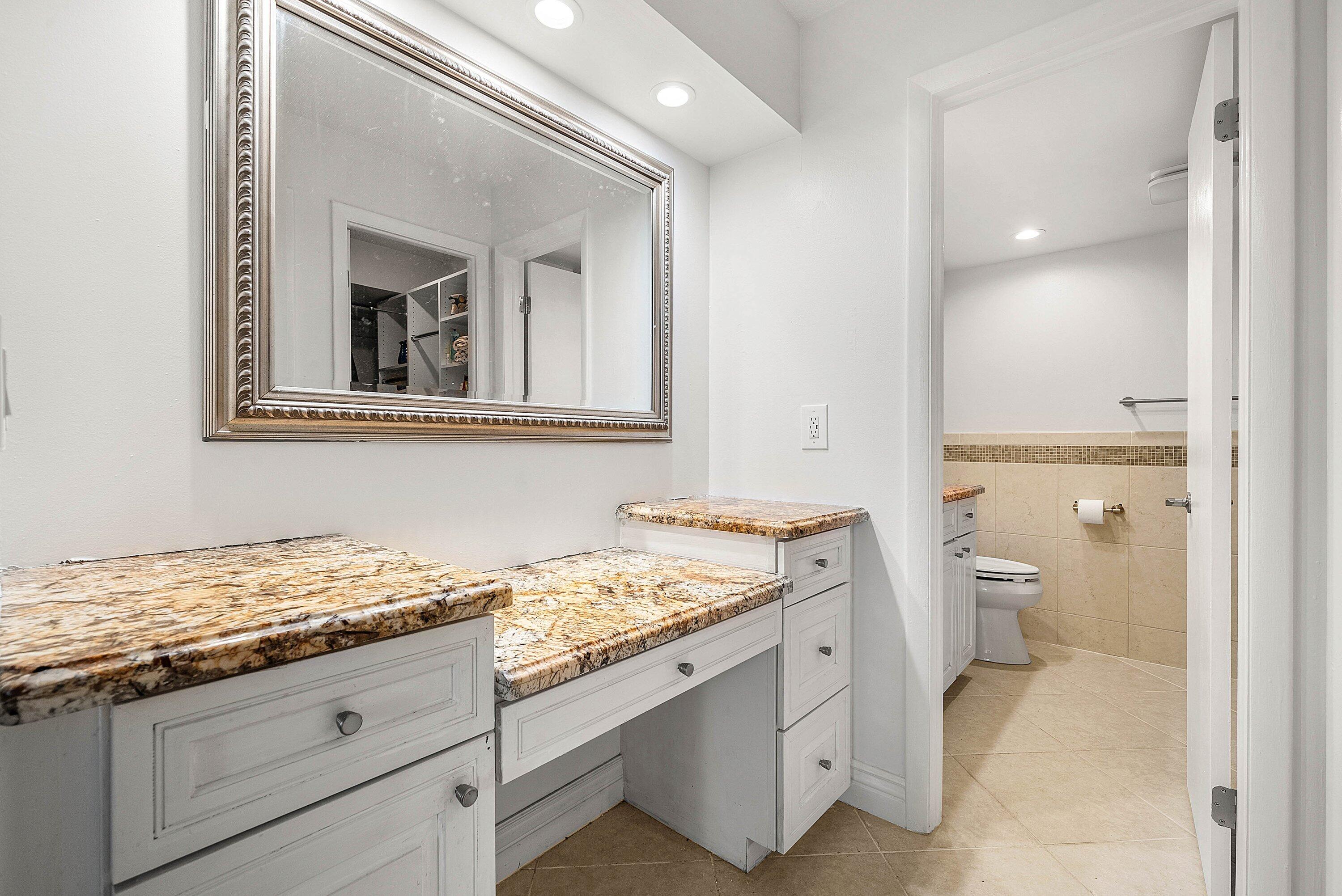 6699 Northwest 2nd Avenue, Unit 415 Boca Raton, FL 33487 - Photo 16 of 27 a bathroom with a granite countertop sink and a mirror