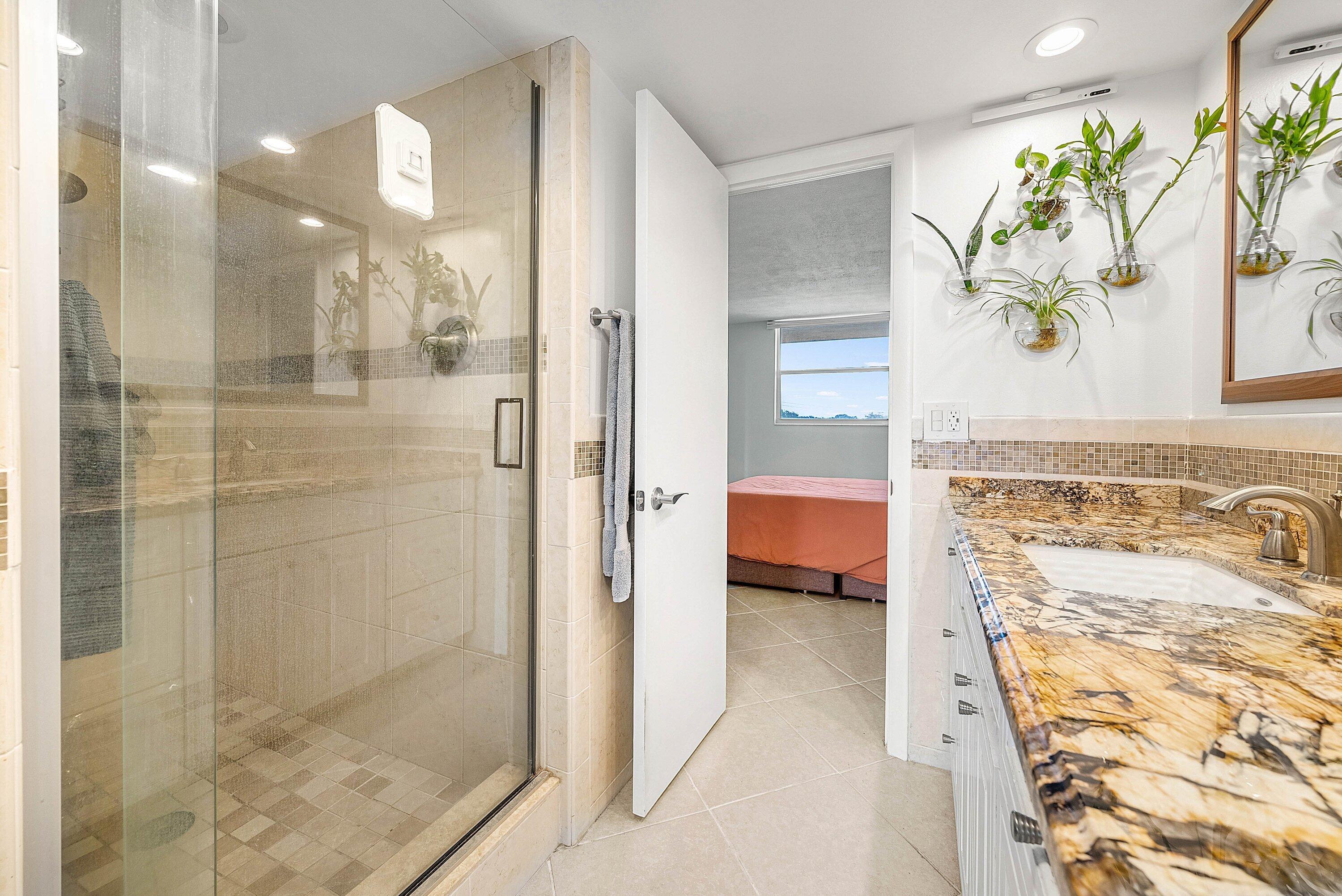 6699 Northwest 2nd Avenue, Unit 415 Boca Raton, FL 33487 - Photo 21 of 27 a bathroom with a shower