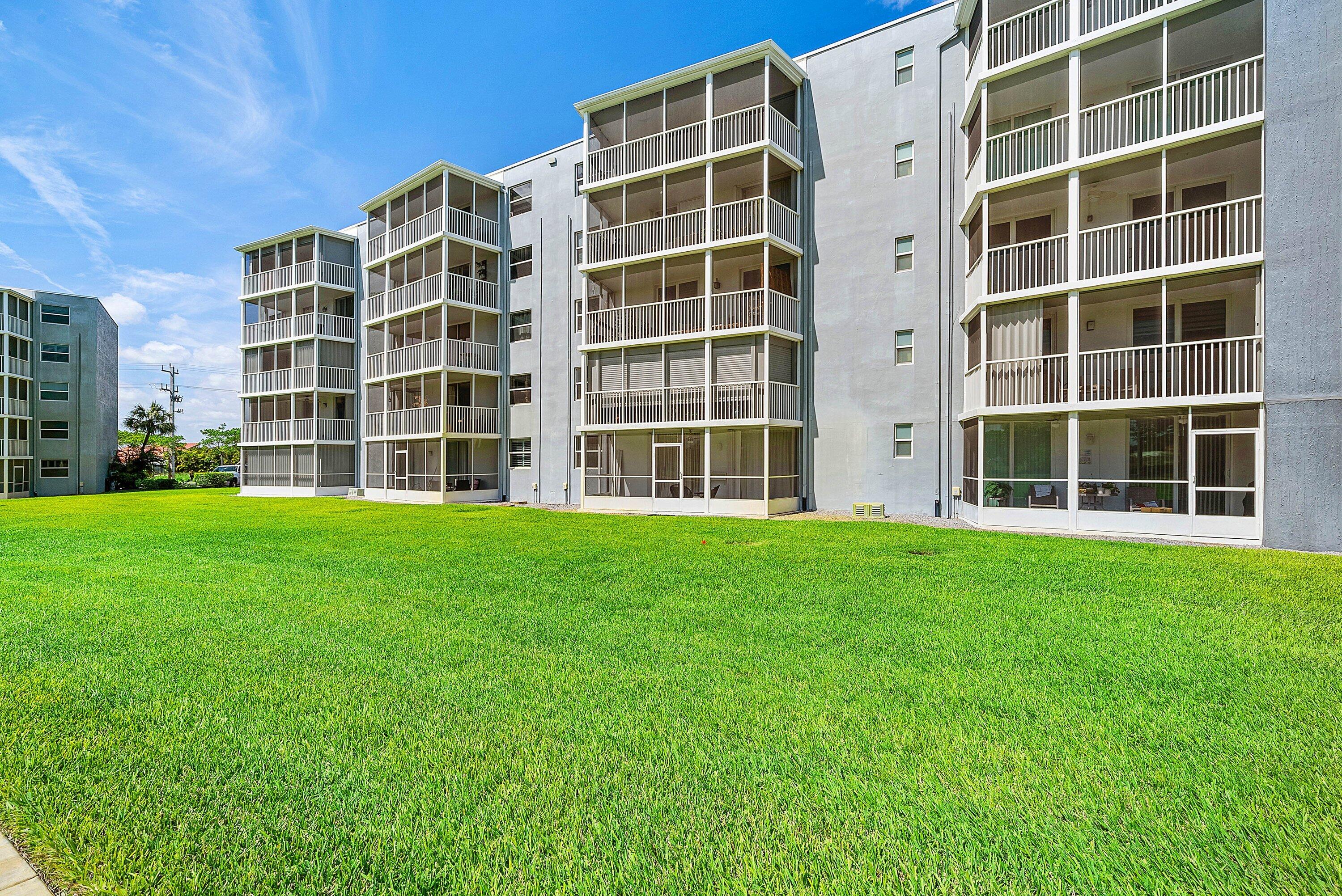 6699 Northwest 2nd Avenue, Unit 415 Boca Raton, FL 33487 - Photo 25 of 27 a view of building with yard