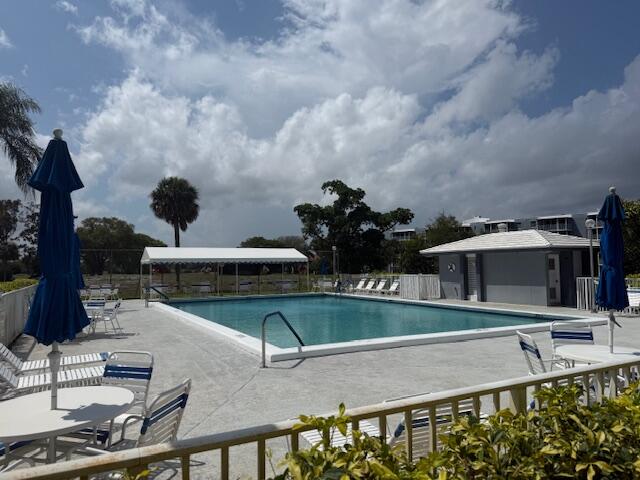 6699 Northwest 2nd Avenue, Unit 415 Boca Raton, FL 33487 - Photo 26 of 27 a view of a swimming pool with a patio