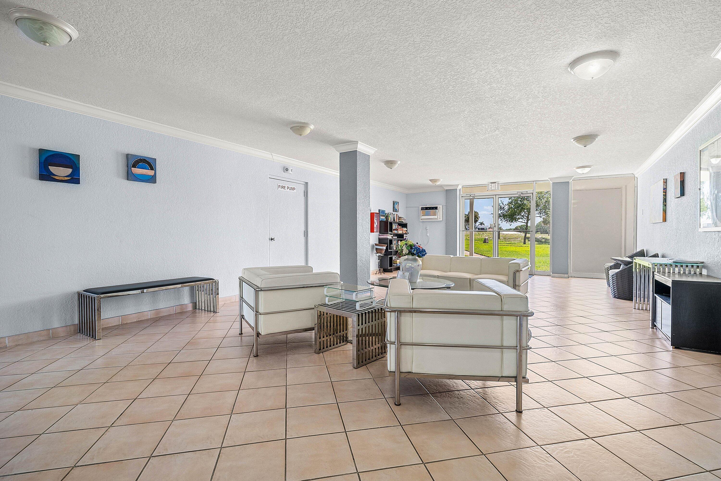 6699 Northwest 2nd Avenue, Unit 415 Boca Raton, FL 33487 - Photo 3 of 27 a living room with furniture and a table