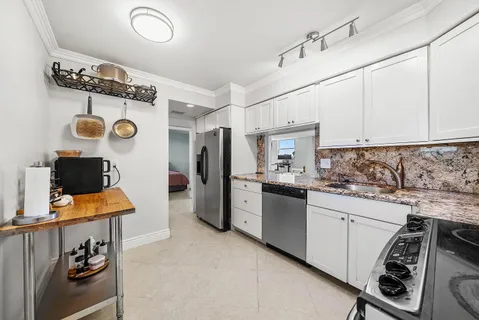 a kitchen with stainless steel appliances granite countertop a sink and cabinets