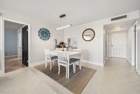 a dining room with furniture and a clock