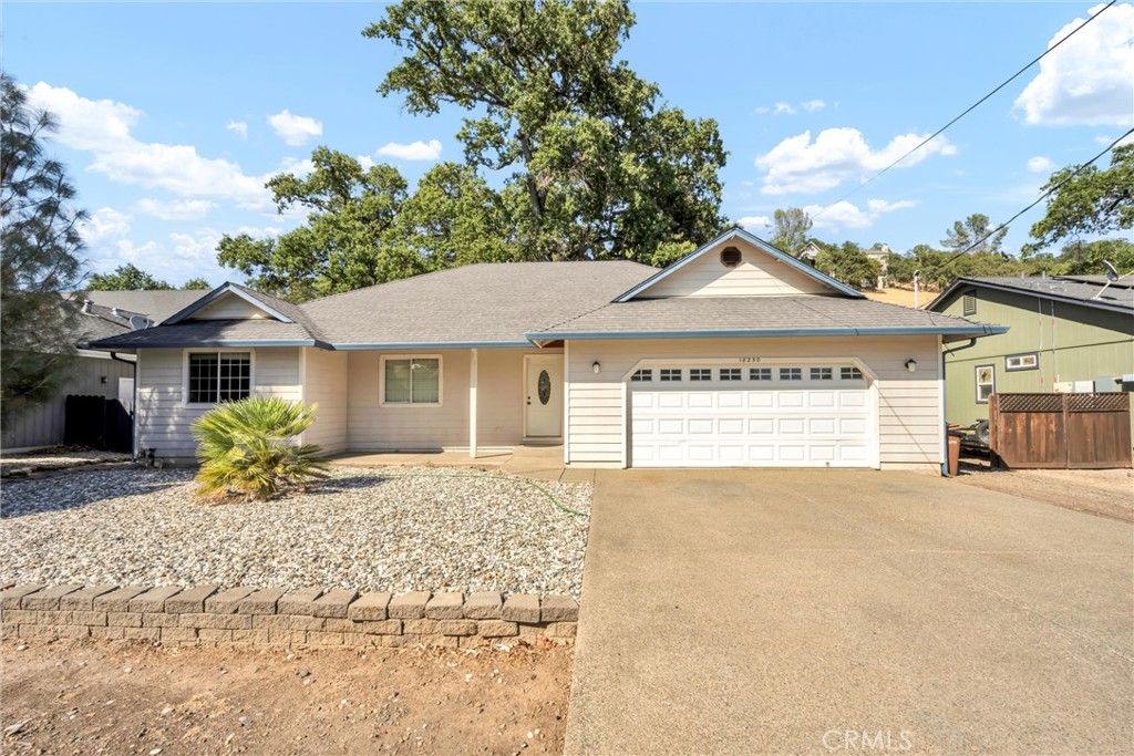 18230 Hidden Valley Road Hidden Valley Lake, CA 95467 - Photo 1 of 22 a front view of a house with a yard and garage