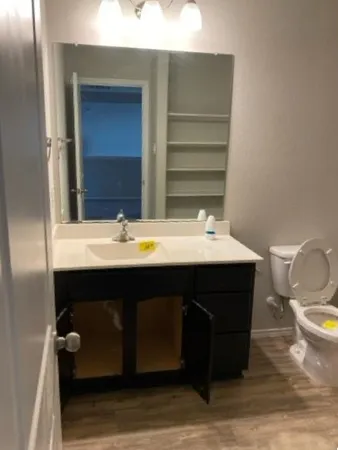 a bathroom with a sink vanity and a mirror