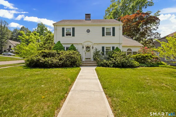 a front view of a house with garden