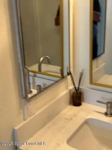 a close view of a sink and a mirror