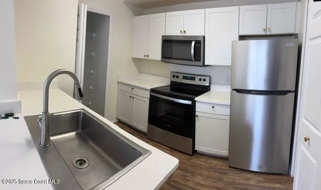 a kitchen with a refrigerator sink and stove