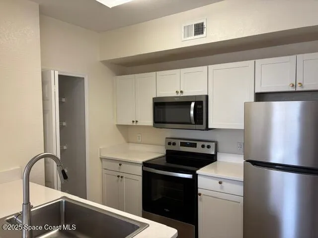 a kitchen with a refrigerator stove and sink