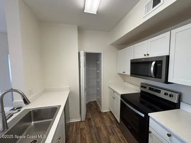 a kitchen that has a sink and a stove top oven