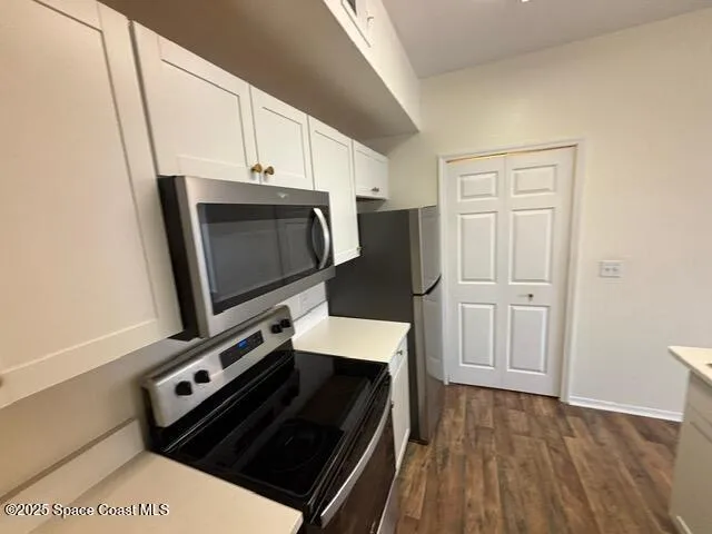 a room with wooden floor and white walls