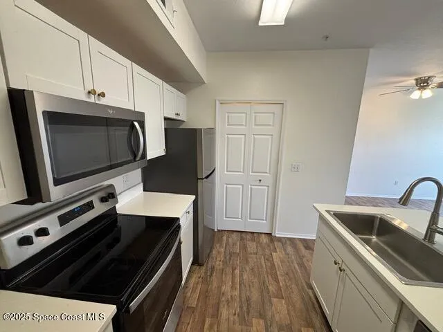 a kitchen with a stove a microwave and a sink