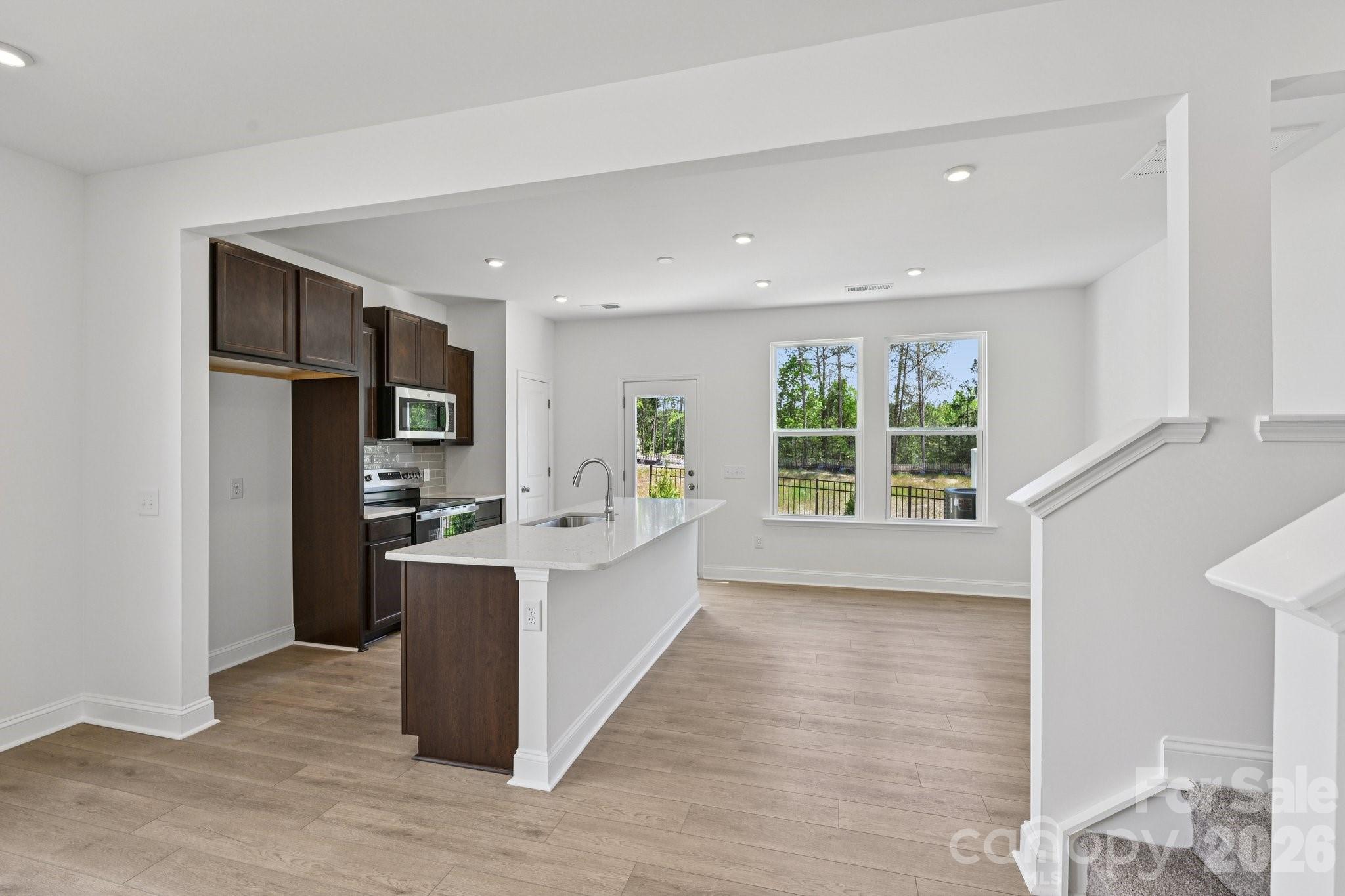 7635 Ethora Way Charlotte, NC 28216 - Photo 11 of 37 a view of kitchen with kitchen island and windows