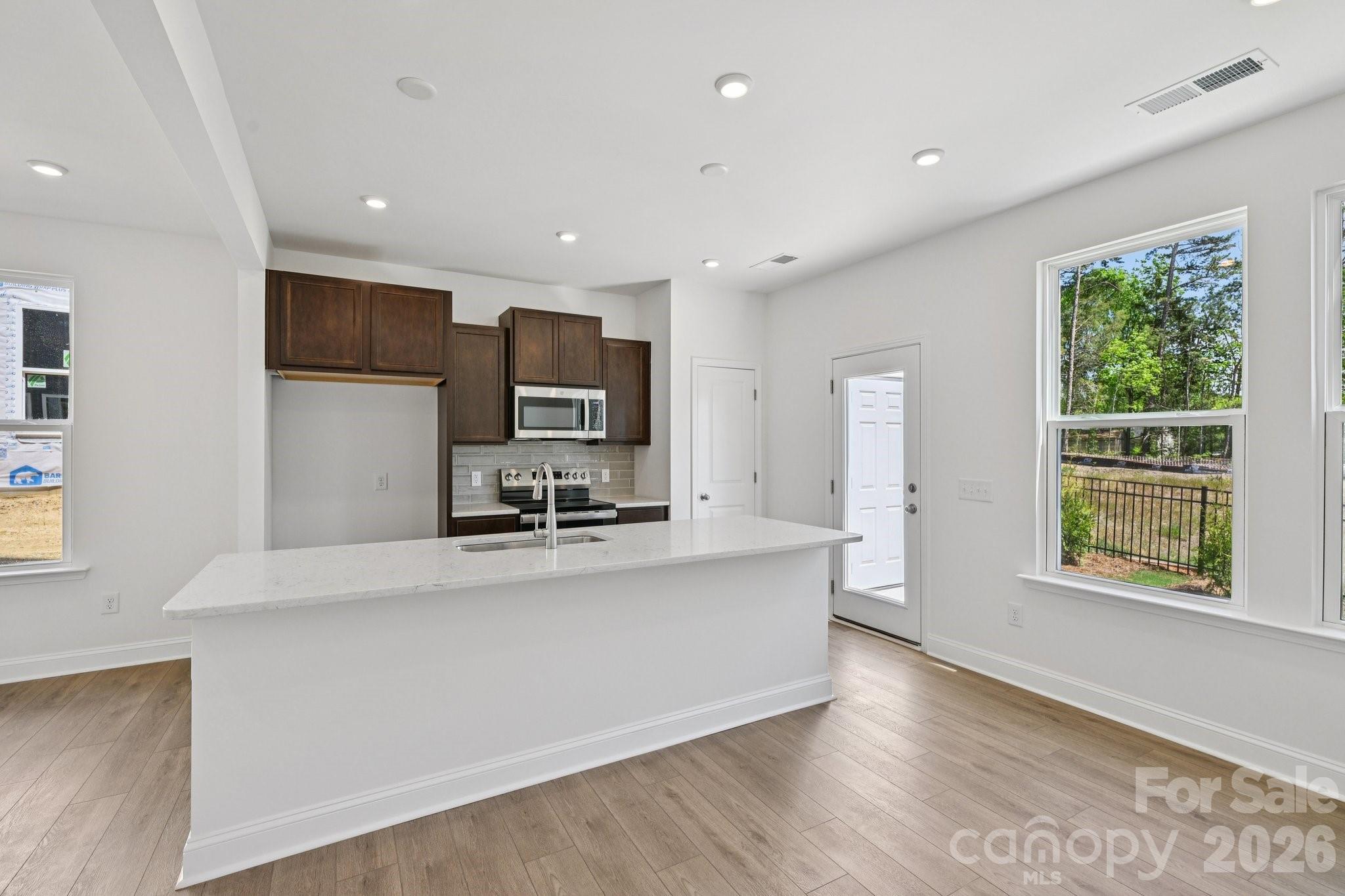 7635 Ethora Way Charlotte, NC 28216 - Photo 12 of 37 a large white kitchen with a large window