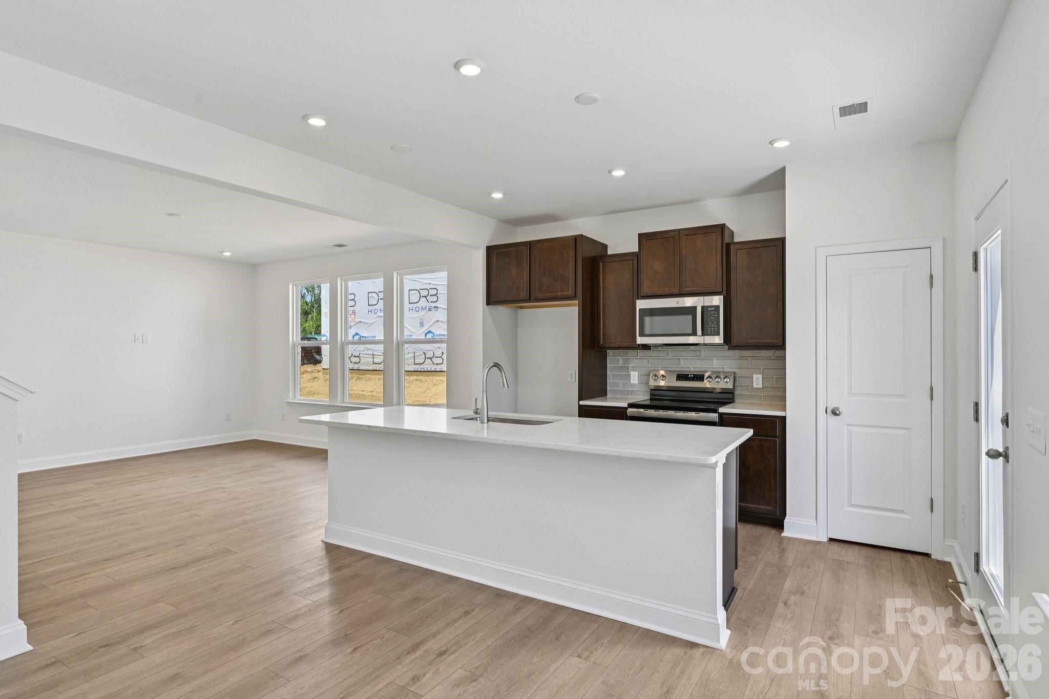 7635 Ethora Way Charlotte, NC 28216 - Photo 14 of 37 a kitchen with stainless steel appliances granite countertop a refrigerator and a stove top oven