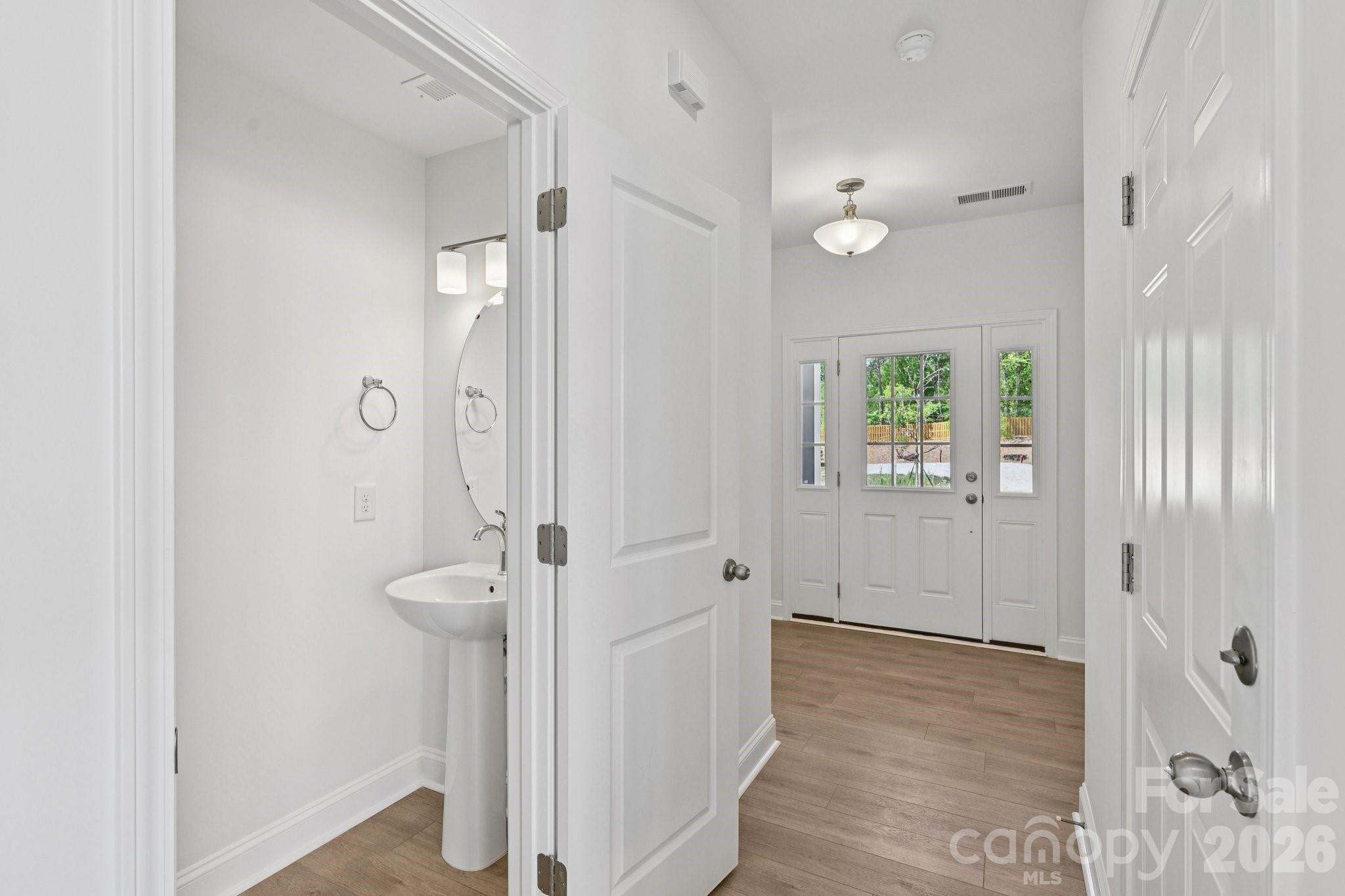 7635 Ethora Way Charlotte, NC 28216 - Photo 17 of 37 a view of a bathroom from a hallway
