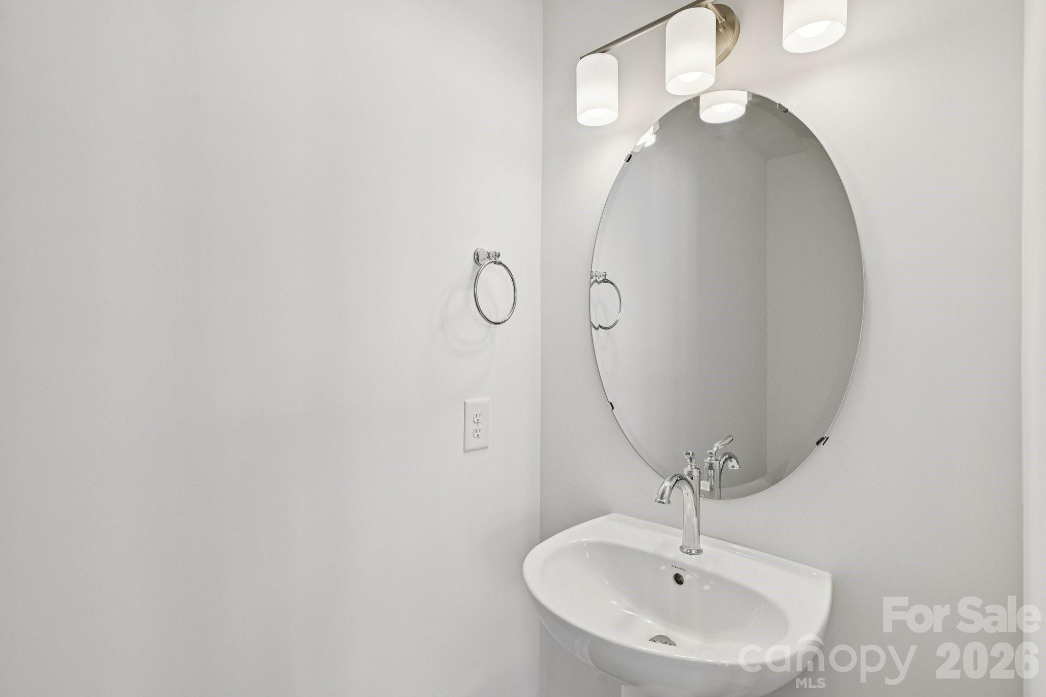 7635 Ethora Way Charlotte, NC 28216 - Photo 18 of 37 a bathroom with a sink and mirror