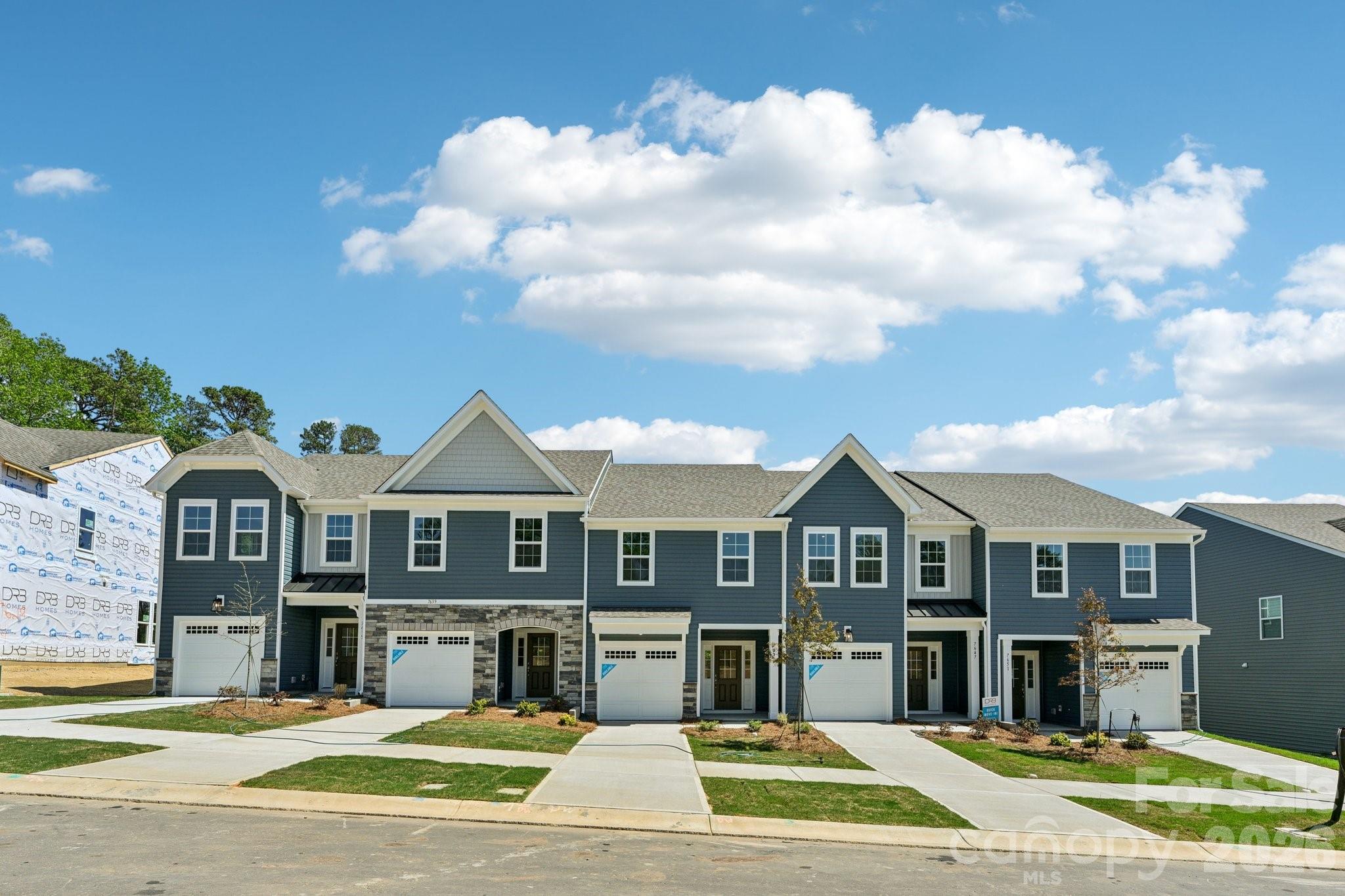7635 Ethora Way Charlotte, NC 28216 - Photo 2 of 37 a front view of residential houses with yard