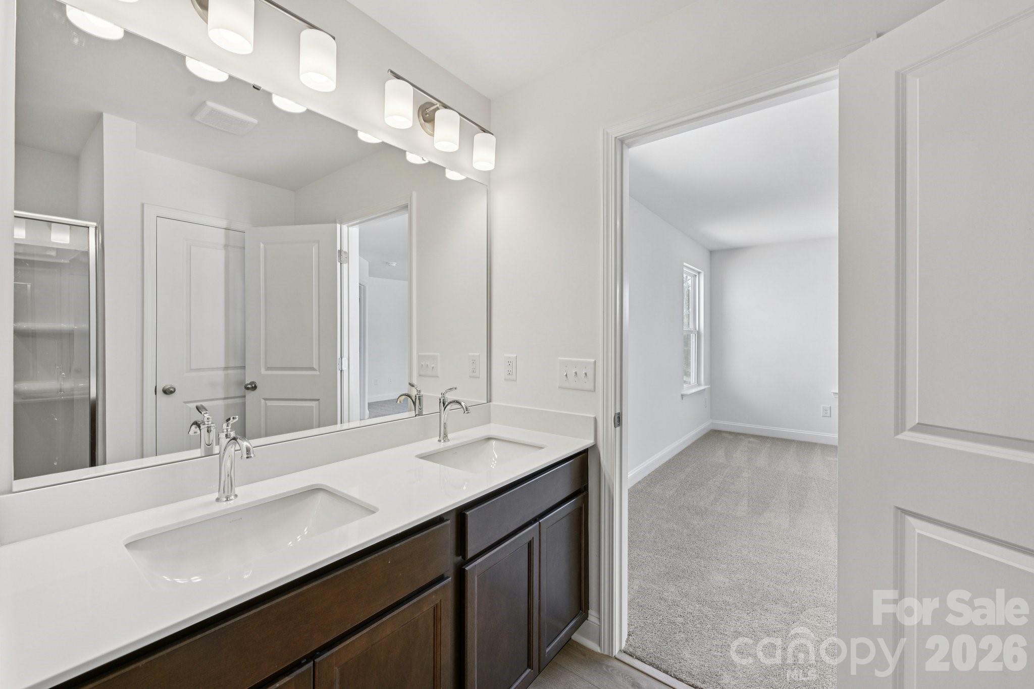 7635 Ethora Way Charlotte, NC 28216 - Photo 30 of 37 a bathroom with a sink double vanity and a mirror
