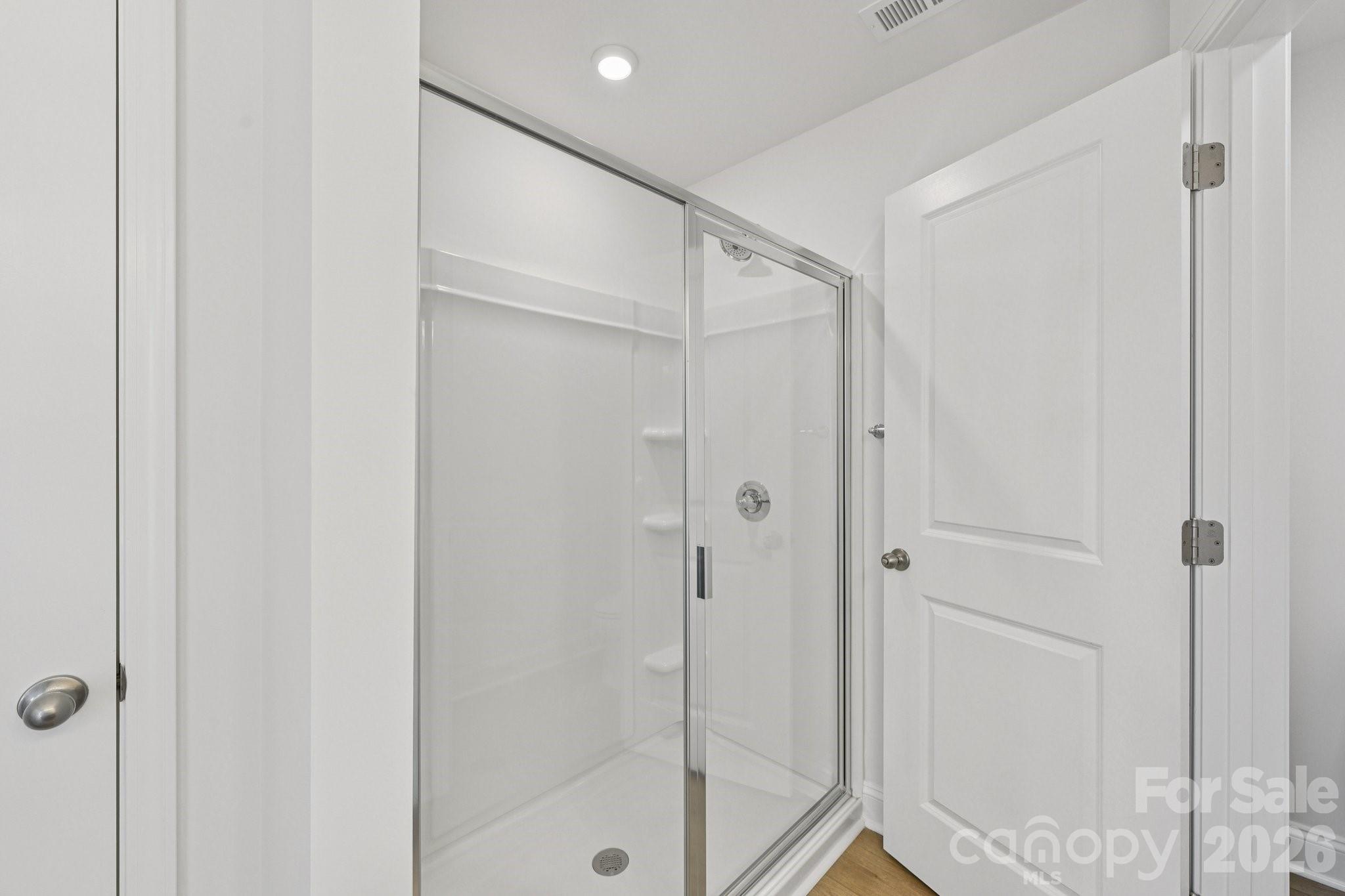 7635 Ethora Way Charlotte, NC 28216 - Photo 31 of 37 a bathroom with a glass shower door