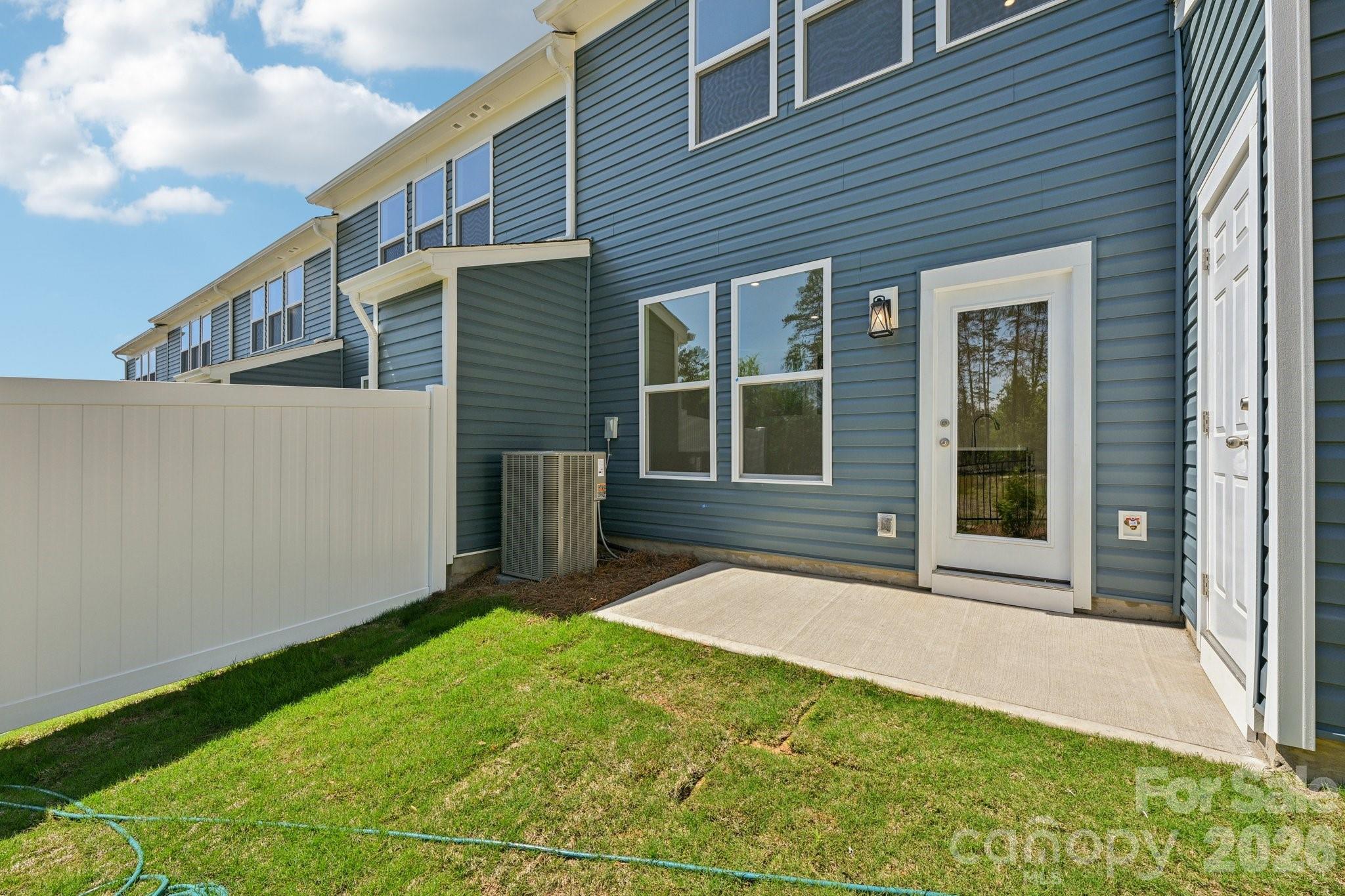 7635 Ethora Way Charlotte, NC 28216 - Photo 34 of 37 a view of house with backyard and glass windows