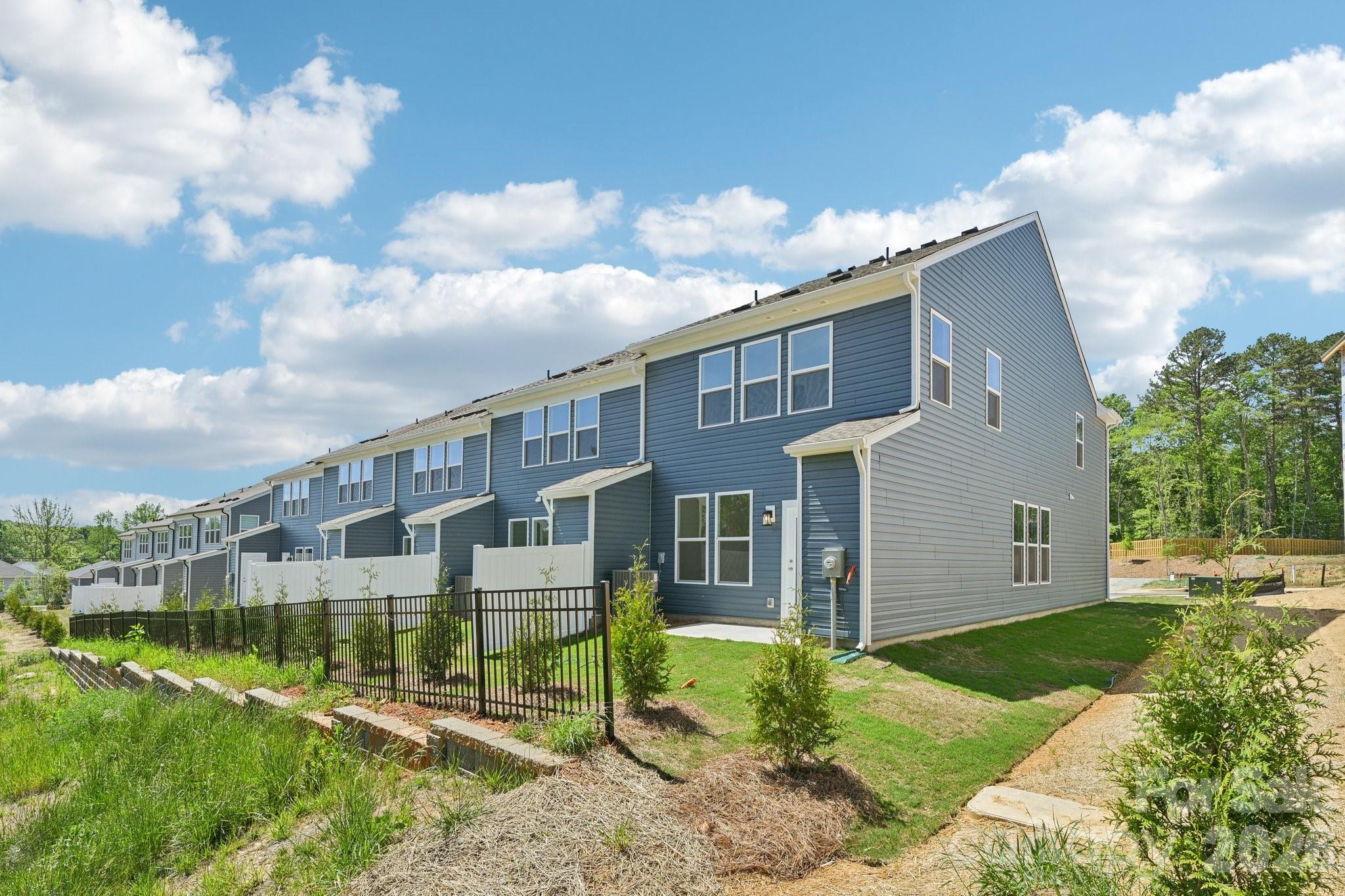 7635 Ethora Way Charlotte, NC 28216 - Photo 35 of 37 a view of a house with a yard