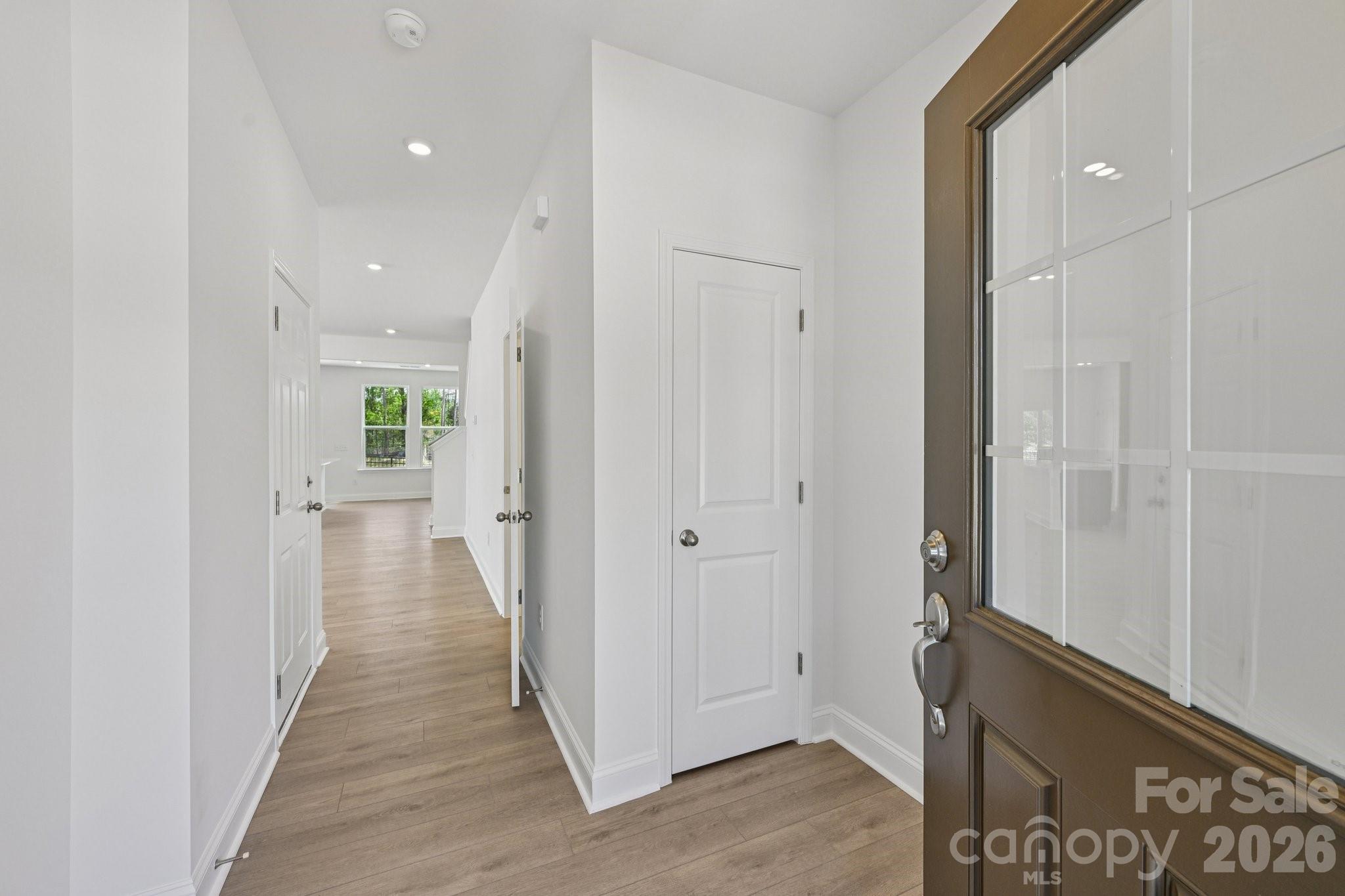 7635 Ethora Way Charlotte, NC 28216 - Photo 4 of 37 a view of a hallway with wooden floor