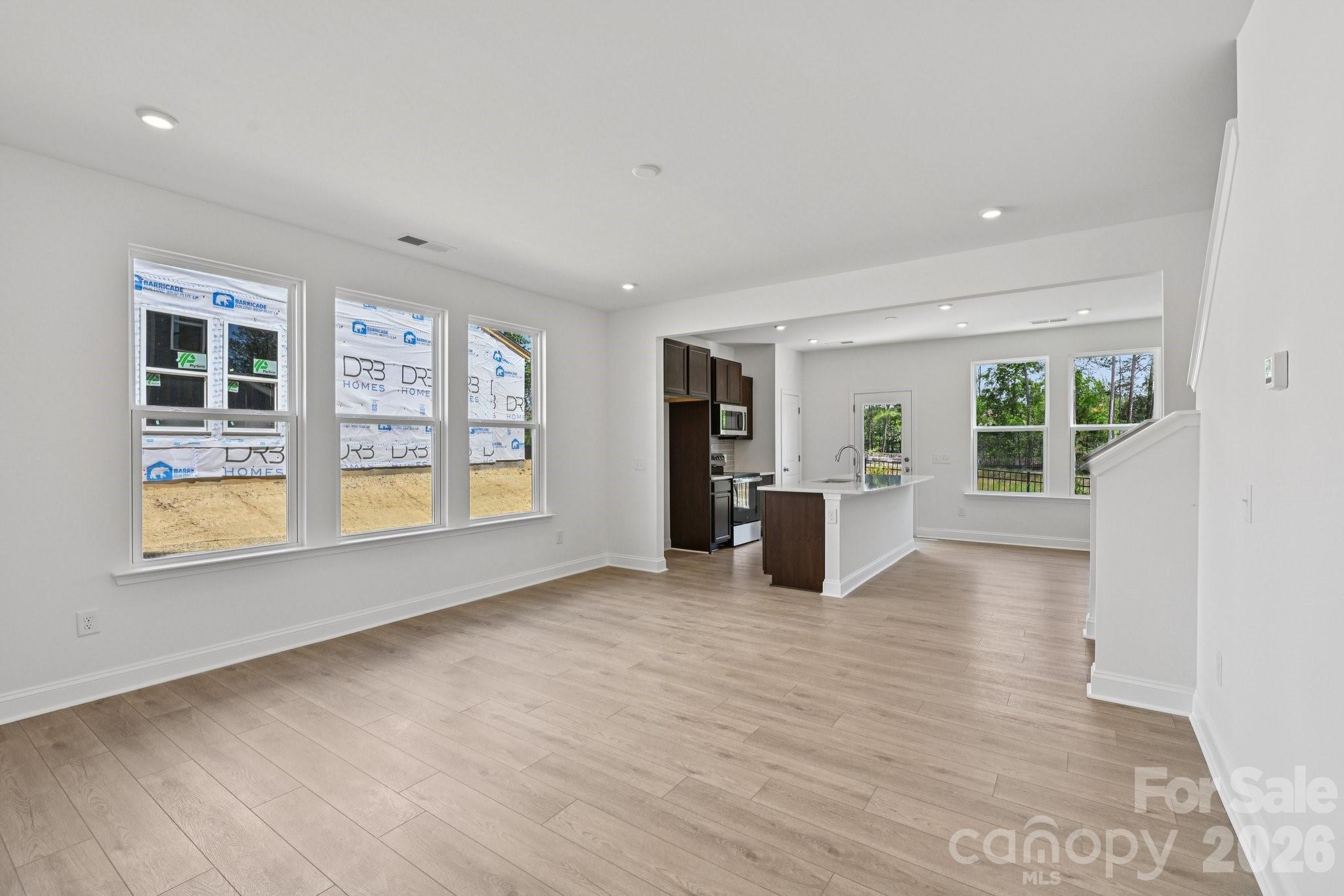 7635 Ethora Way Charlotte, NC 28216 - Photo 6 of 37 a view of an empty room with a window and wooden floor