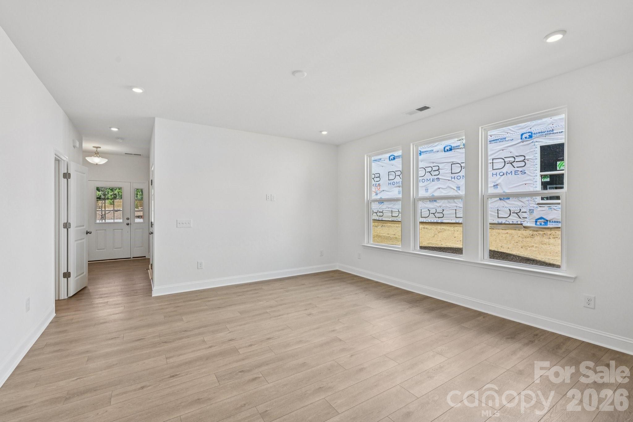 7635 Ethora Way Charlotte, NC 28216 - Photo 7 of 37 wooden floor in an empty room with a window