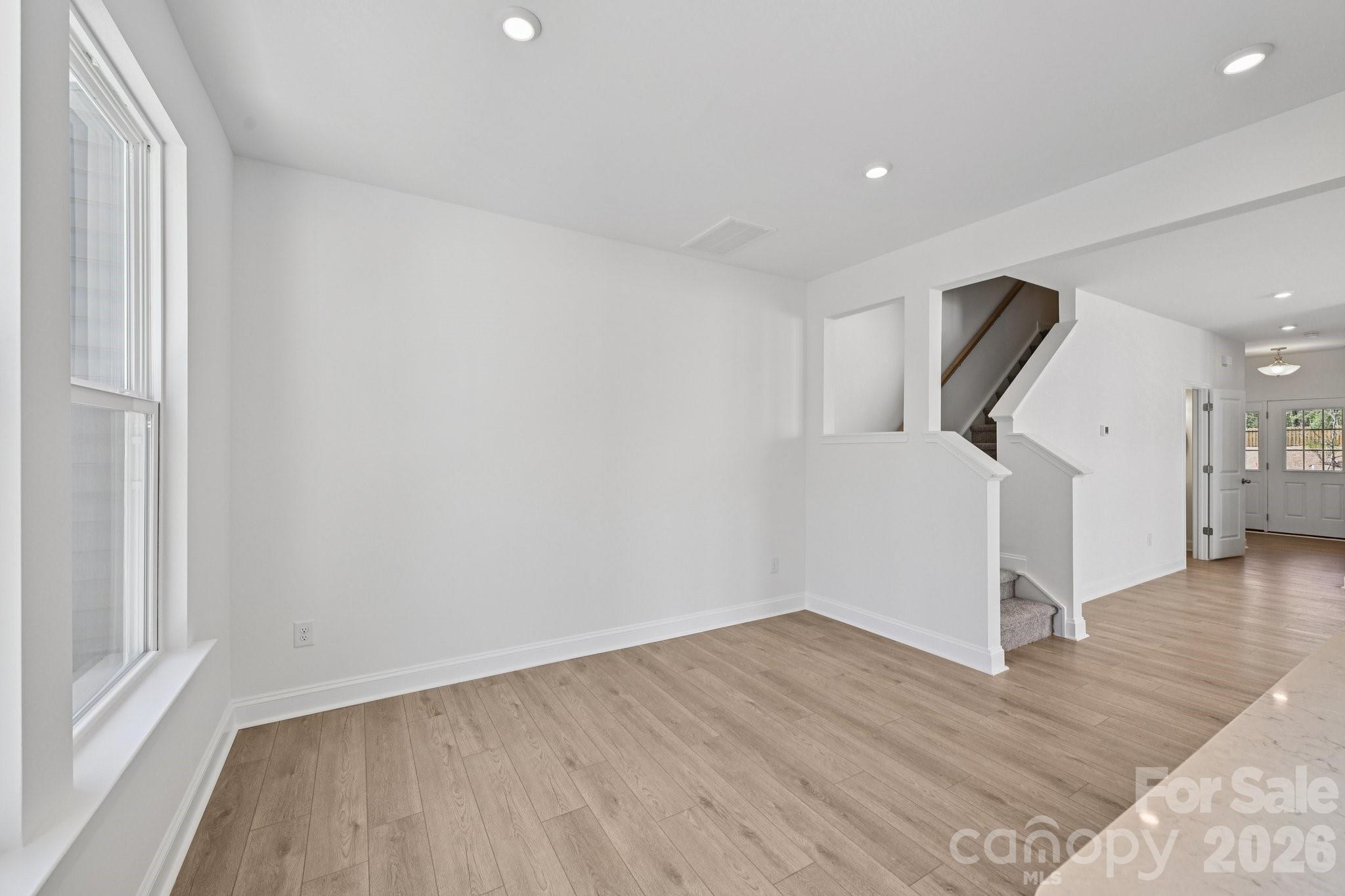 7635 Ethora Way Charlotte, NC 28216 - Photo 9 of 37 a view of a room with wooden floor and stairs