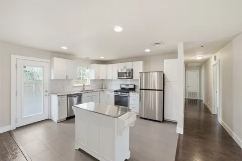 a kitchen with a refrigerator and a sink