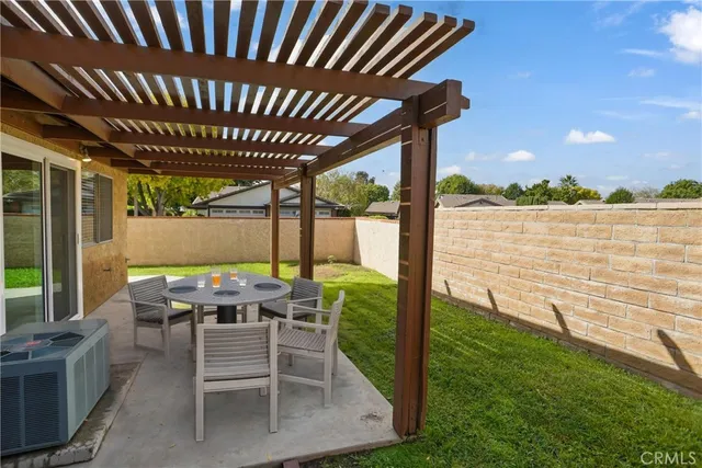 a patio with water view fountain with outdoor seating