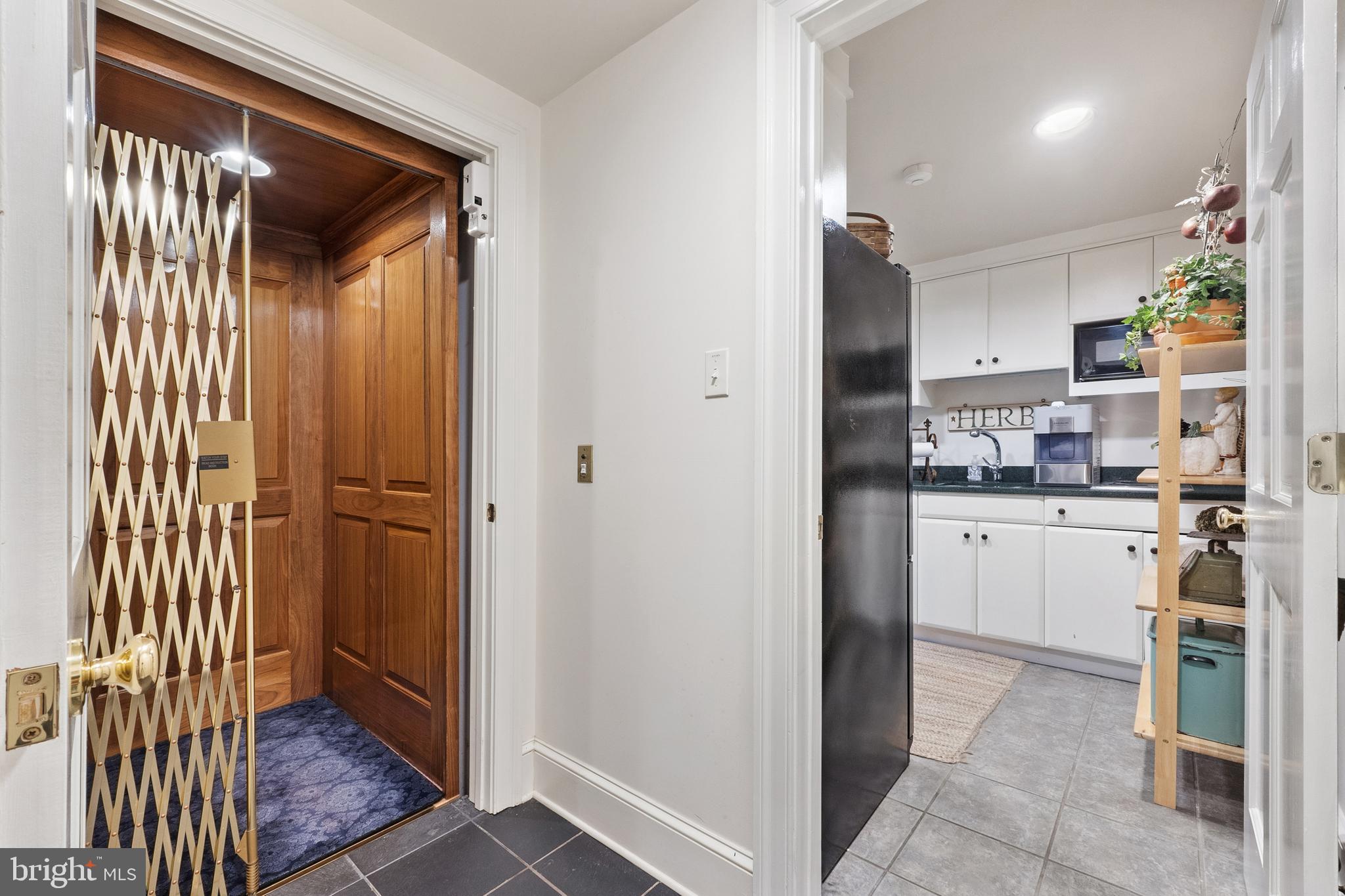 3252 Winchester Road Delaplane, VA 20144 - Photo 45 of 74 a kitchen with a refrigerator and white cabinets