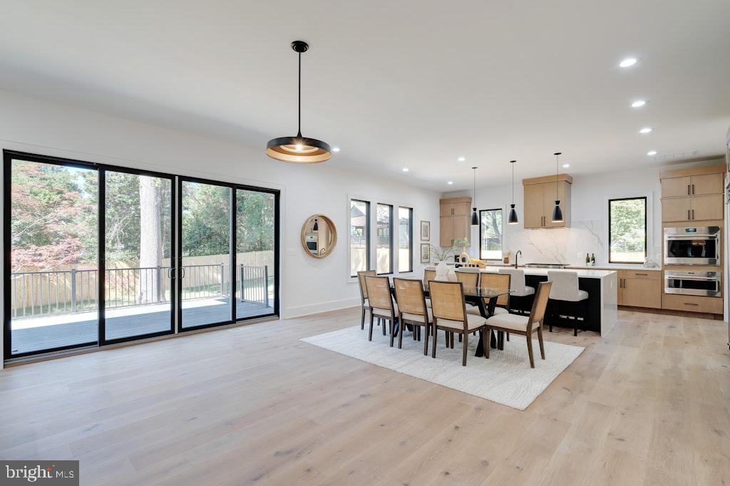 5225 Little Falls Road Arlington, VA 22207 - Photo 15 of 60 a view of a dining room and livingroom with furniture wooden floor a chandelier