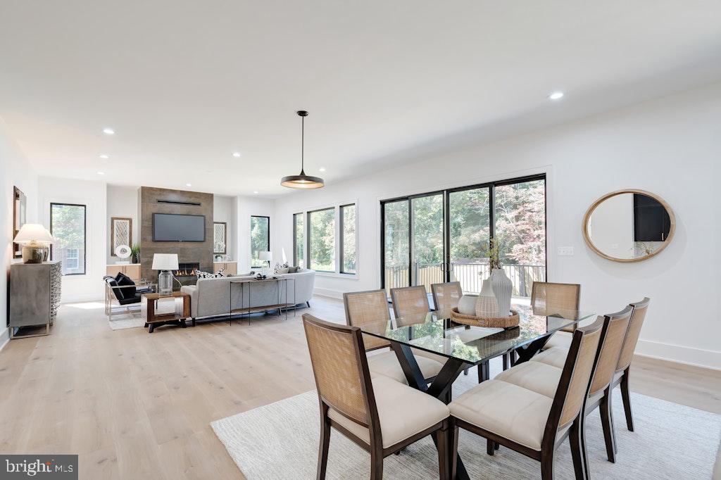 5225 Little Falls Road Arlington, VA 22207 - Photo 16 of 60 a dining room with furniture a chandelier and wooden floor