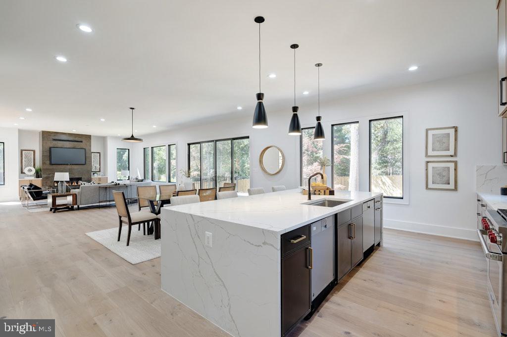 5225 Little Falls Road Arlington, VA 22207 - Photo 20 of 60 a large kitchen with stainless steel appliances kitchen island granite countertop a sink and cabinets