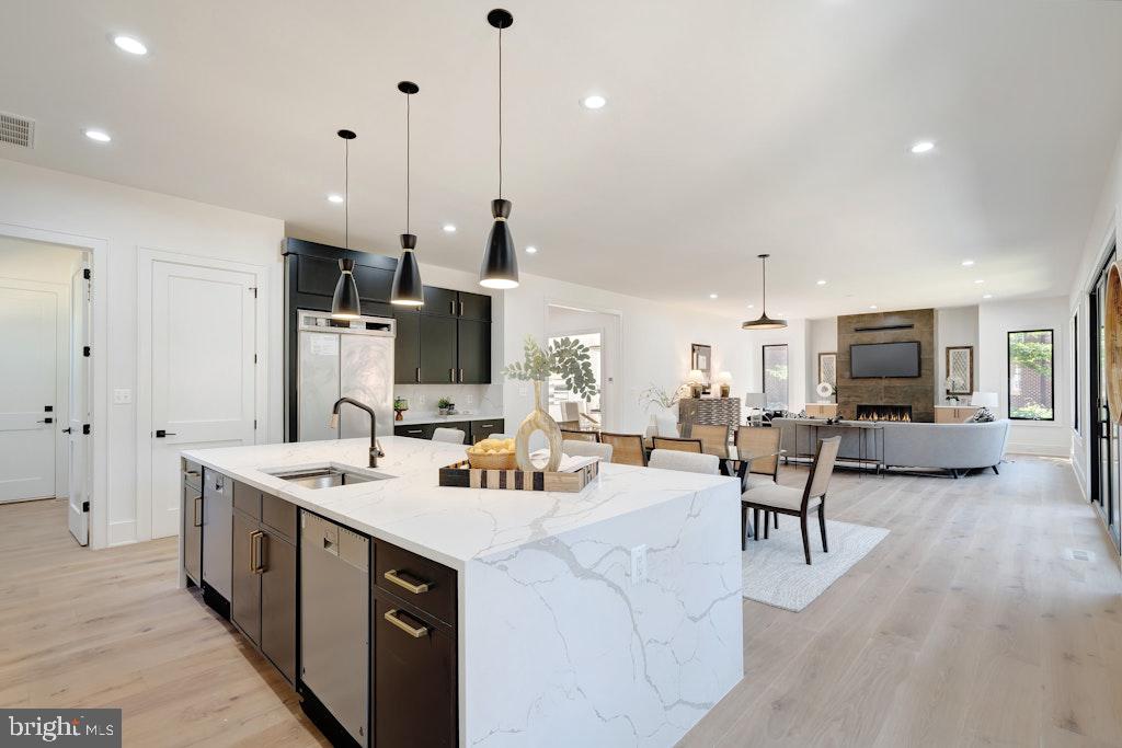 5225 Little Falls Road Arlington, VA 22207 - Photo 22 of 60 a open kitchen with stainless steel appliances kitchen island a large island in the center