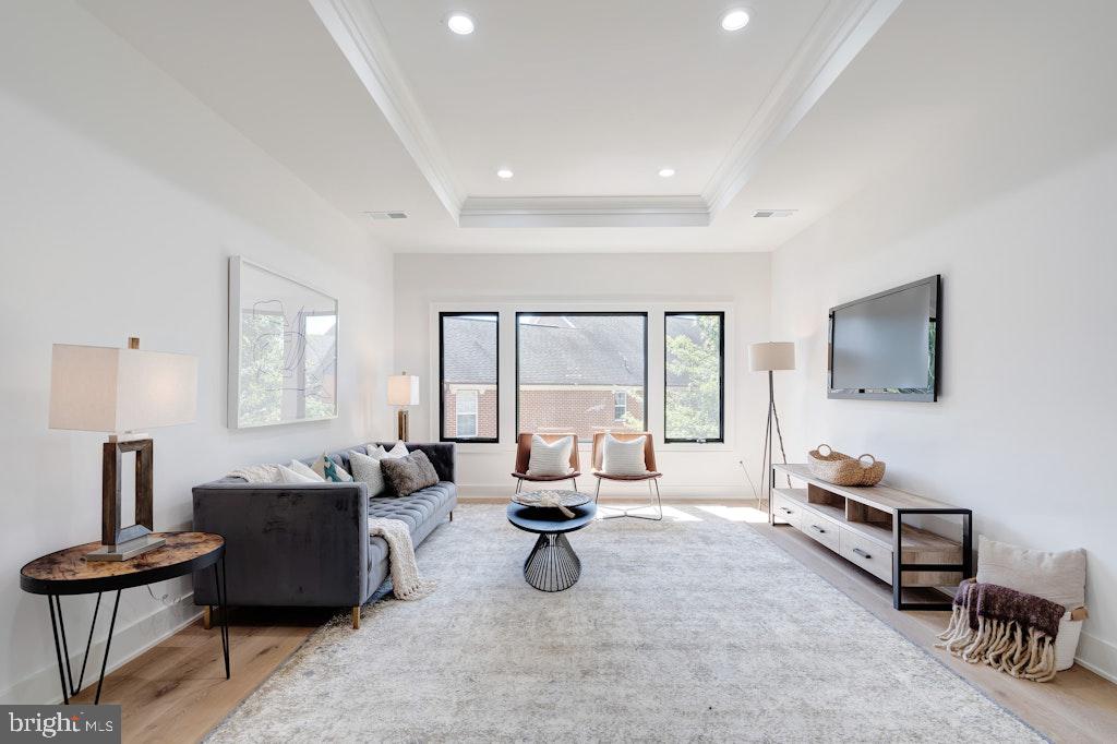 5225 Little Falls Road Arlington, VA 22207 - Photo 27 of 60 a living room with furniture a flat screen tv and large window