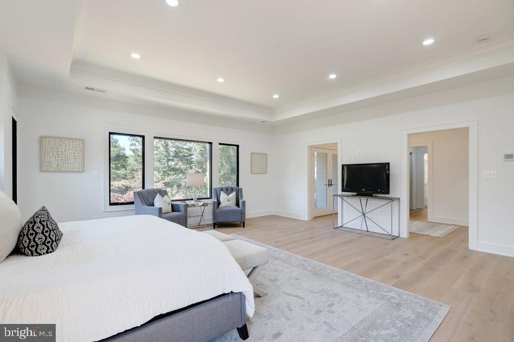 5225 Little Falls Road Arlington, VA 22207 - Photo 31 of 60 a large bedroom with a bed and a flat screen tv