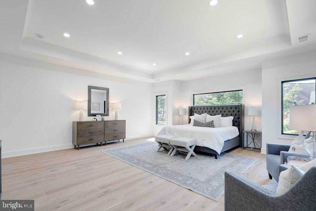 5225 Little Falls Road Arlington, VA 22207 - Photo 32 of 60 a spacious bedroom with a bed a couch and dresser