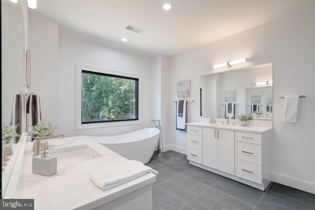 5225 Little Falls Road Arlington, VA 22207 - Photo 34 of 60 a bathroom with a sink and a large mirror