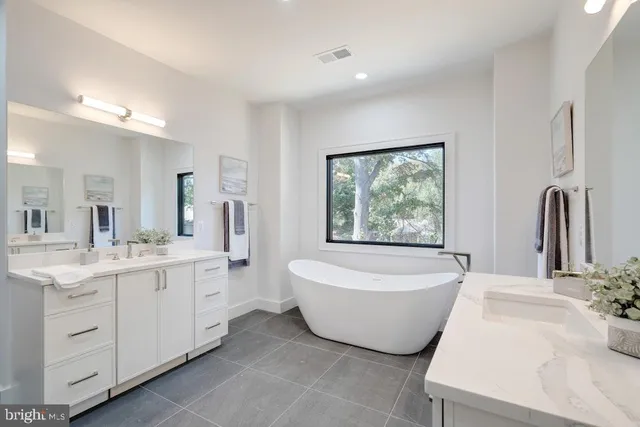 a bathroom with a sink mirror toilet and bathtub