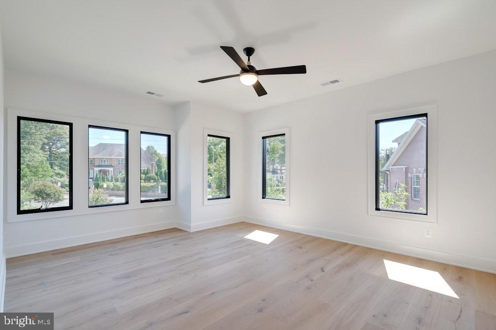 5225 Little Falls Road Arlington, VA 22207 - Photo 39 of 60 a view of an empty room with a window and wooden floor
