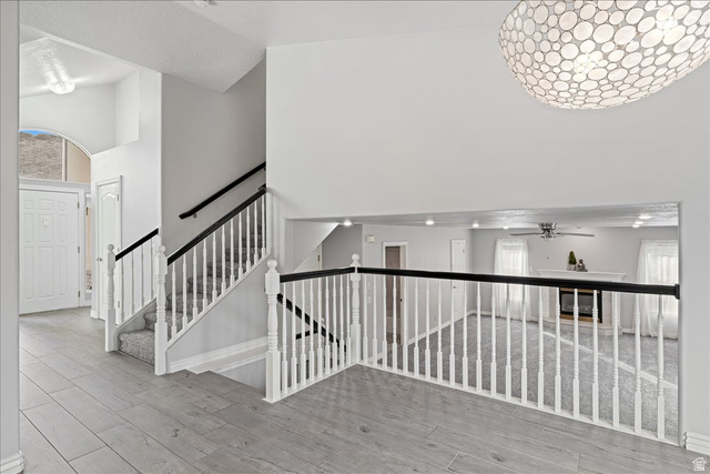 7 Reflection Way St. George, UT 84770 - Photo 32 of 54 Staircase with a towering ceiling, wood finished floors, and a ceiling fan
