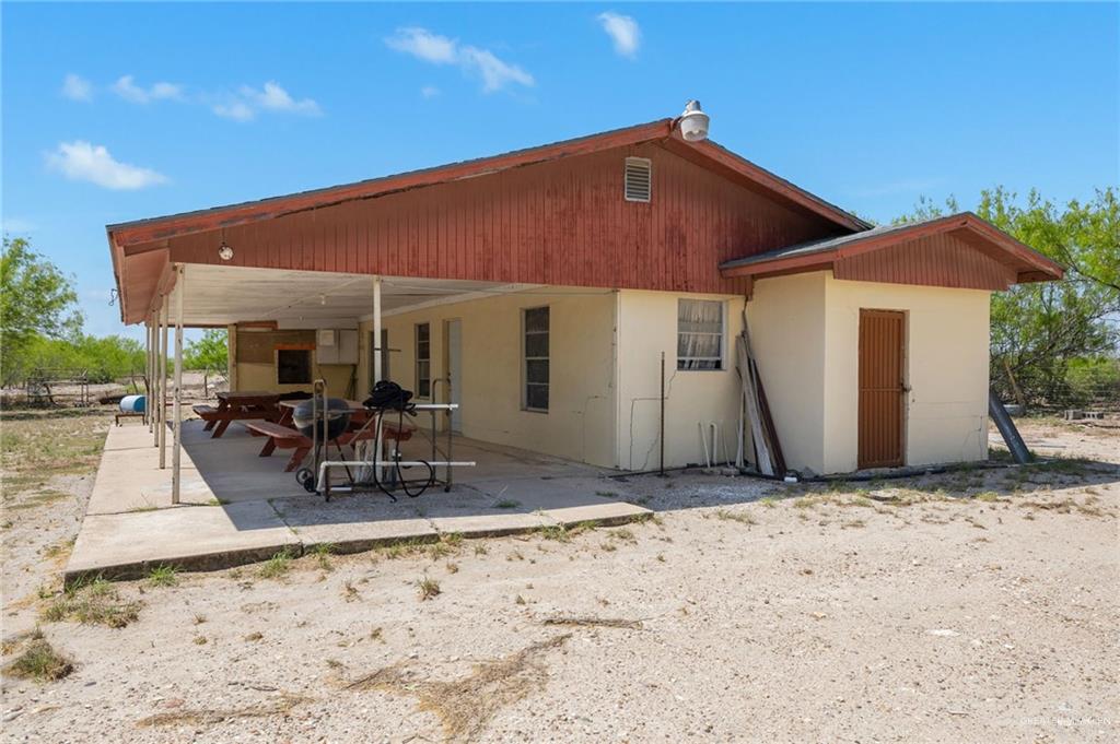 0 65th Roma, TX 78584 - Photo 5 of 15 a patio with a table and chairs under an umbrella