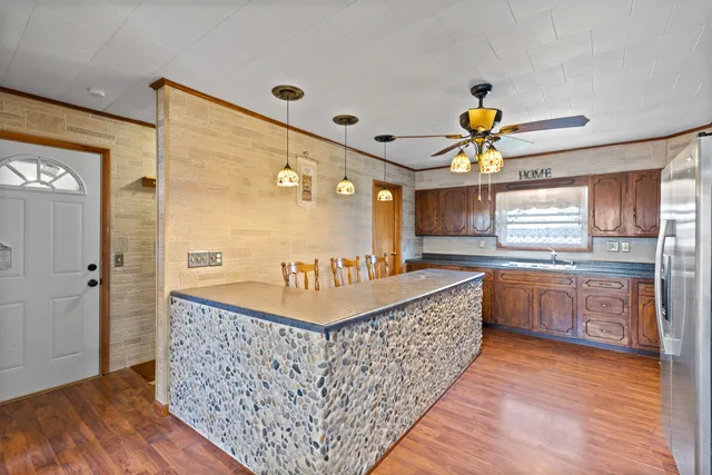 a bathroom with a granite countertop tub a sink and a large window